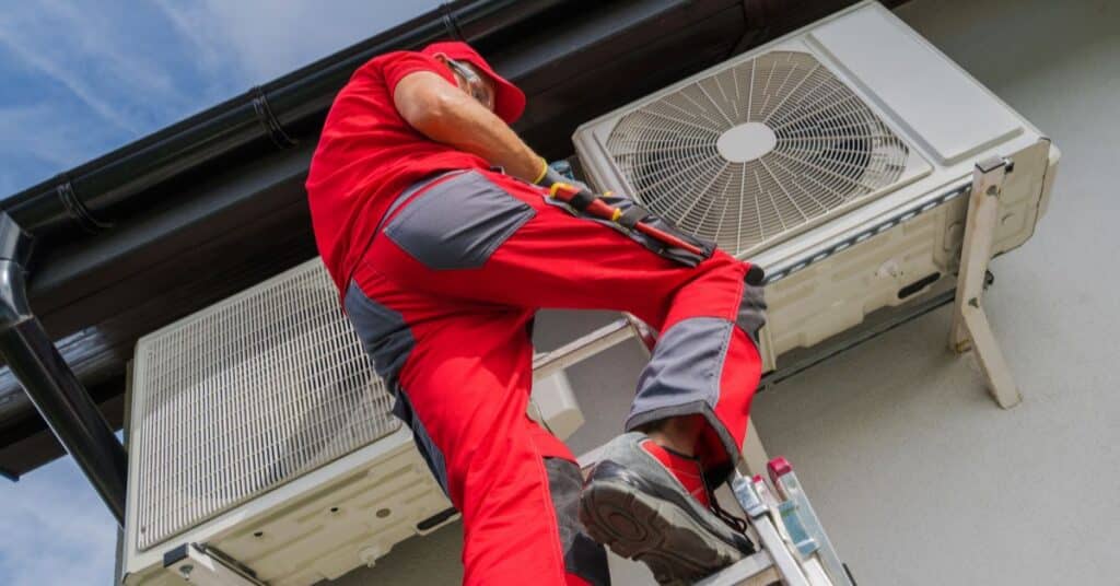 HVAC Technician Servicing AC Condenser Unit