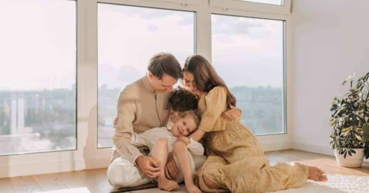 A joyful family sitting together in their cozy home, smiling and radiating happiness.