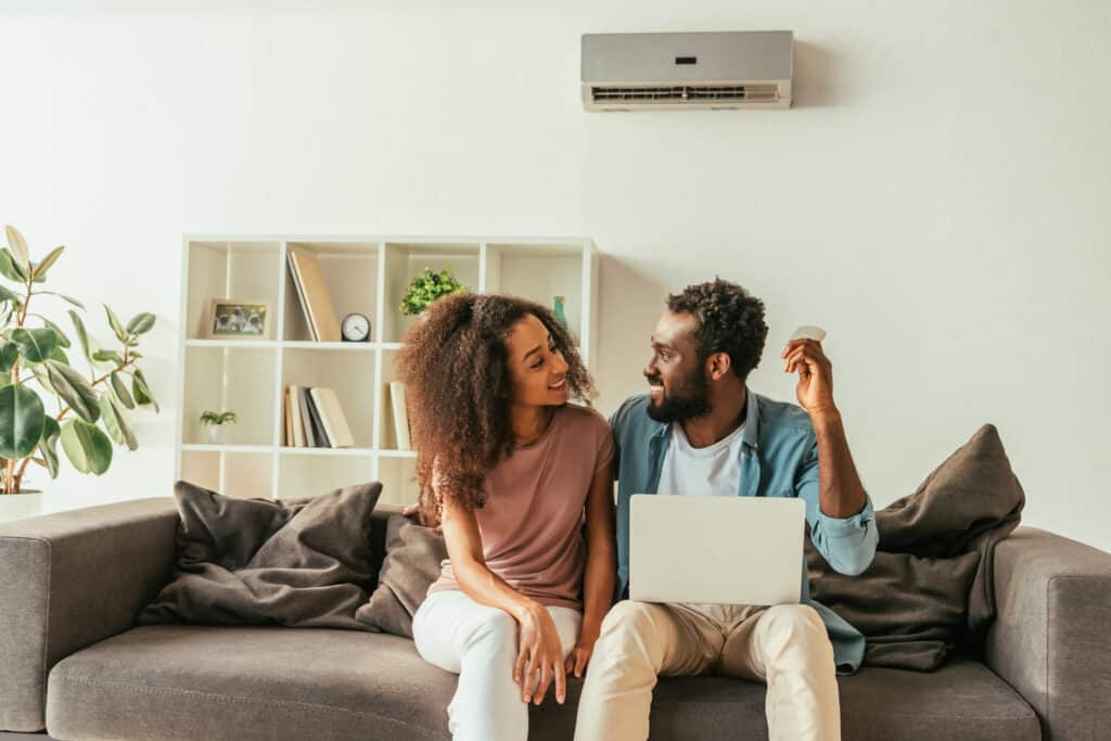 Happy couple relaxing in a cozy, temperature-controlled home