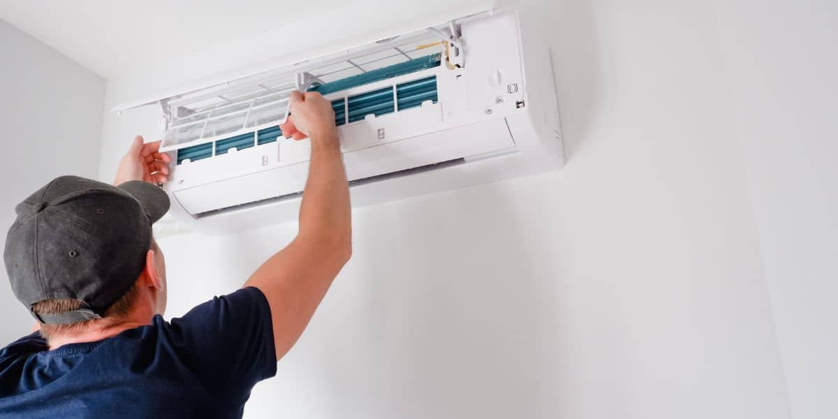 HVAC repairmen fixing an air conditioner.