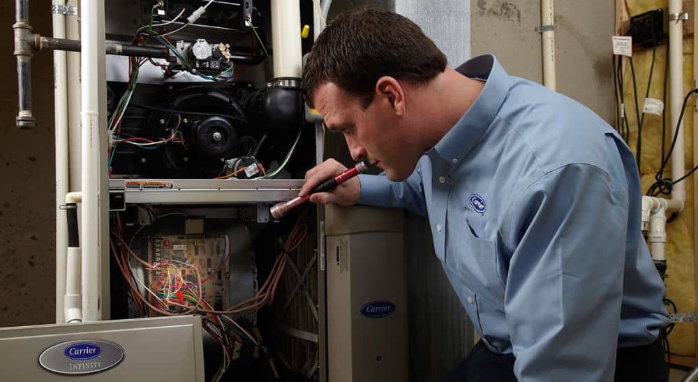 Furnace Technician Inspecting the Inside of a Furnace